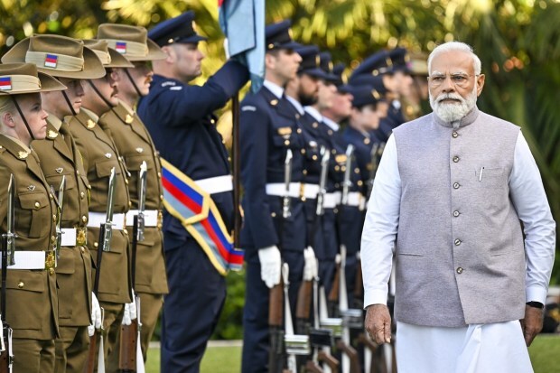 Prime Minister Narendra Modi inspects a military parade during a ceremonial welcome at Admiralty House in Sydney. (Image/AP)