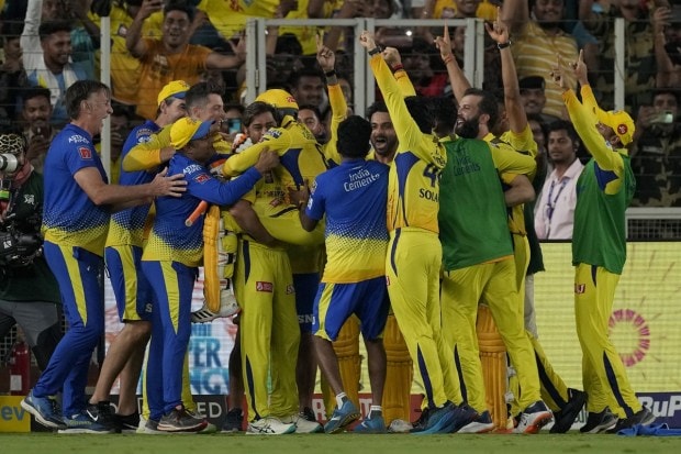 MS Dhoni, center, lifts teammate Ravindra Jadeja to celebrate after their win in the IPL final cricket match between Chennai Super Kings and Gujarat Titans in Ahmedabad. (Image: AP)