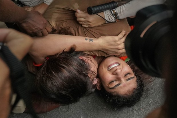 Security personnel detain wrestlers Vinesh Phogat and Sangeeta Phogat during wrestlers' protest march towards the new Parliament building in New Delhi on Sunday. (Photo: PTI)
