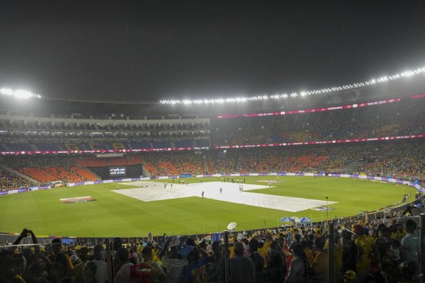 Covers back on the pitch due to constant rainfall ahead of the IPL 2023 final cricket match between Gujarat Titans and Mumbai Indians at the Narendra Modi Stadium in Ahmedabad. (Image/PTI)