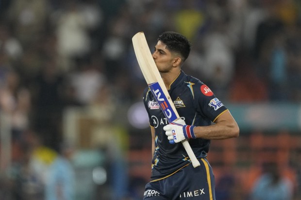 Gujrat Titans' Shubman Gill kisses his bat after scoring his century during the Indian Premier League qualifier cricket match between Gujarat Titans and Mumbai Indians in Ahmedabad on Friday. (Photo: AP)