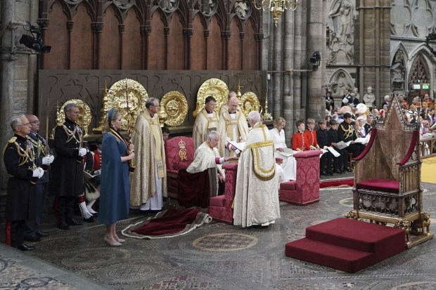 King Charles III, sits as he touches a book during the coronation ceremony at Westminster Abbey, London, Saturday. (Photo: AP)