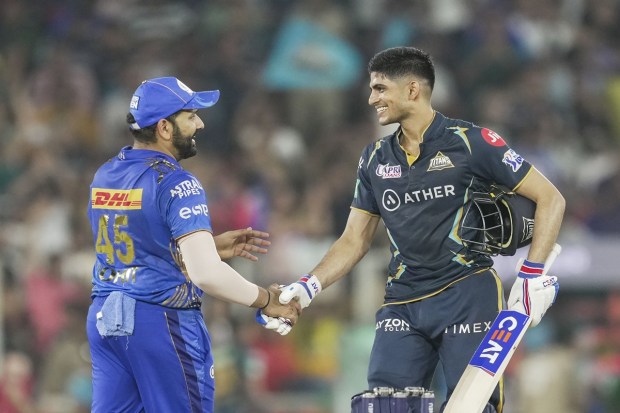 Gujarat Titans batter Shubman Gill celebrates his century as Mumbai Indians captain Rohit Sharma greets him during the IPL 2023 cricket playoff match between Gujarat Titans and Mumbai Indians at the Narendra Modi Stadium in Ahmedabad on Friday. (Photo: PTI)