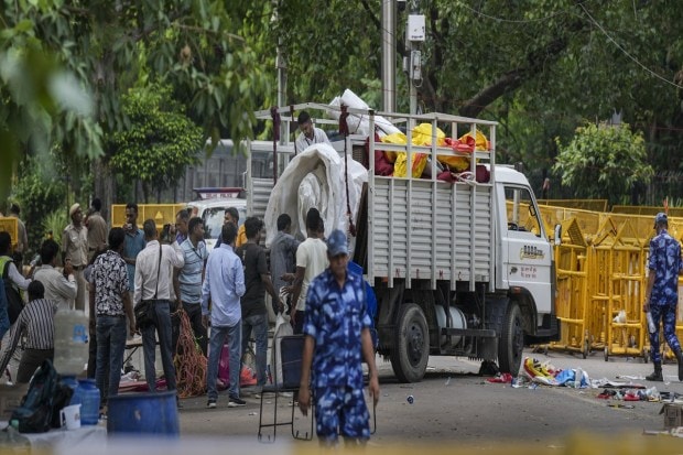 Authorities clear the site of the wrestler's protest at Jantar Mantar in New Delhi on Sunday. The police officers began clearing the protest site by removing the cots, mattresses, coolers, fans and the tarpaulin ceiling along with other belongings of the wrestlers. (Photo: PTI)