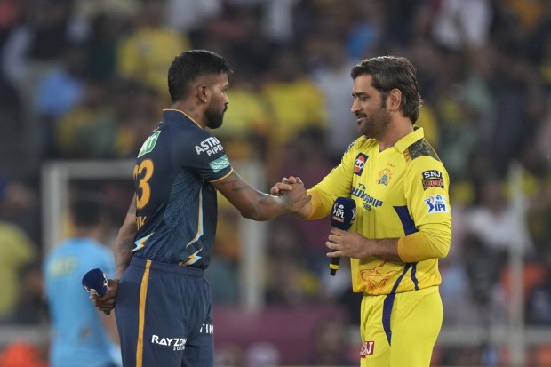 MS Dhoni, right, shakes hands with Gujarat Titans' captain Hardik Pandya at the toss ahead of the final cricket match of IPL between Gujarat Titans and Chennai Super Kings in Ahmedabad on May 29, 2023. (Image: AP)