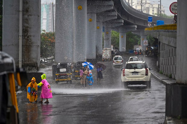 Vehicles move on a road amid rain in Mumbai. (Image: PTI)