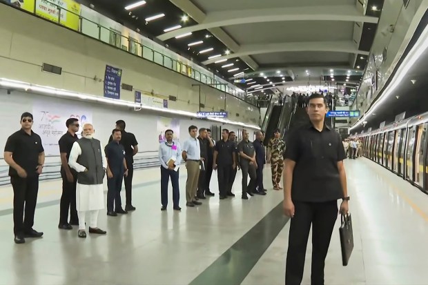Prime Minister Narendra Modi waits to board at Delhi Metro train to reach the Delhi University to attend its centenary celebrations, in New Delhi, Friday, June 30, 2023. (PTI Photo)