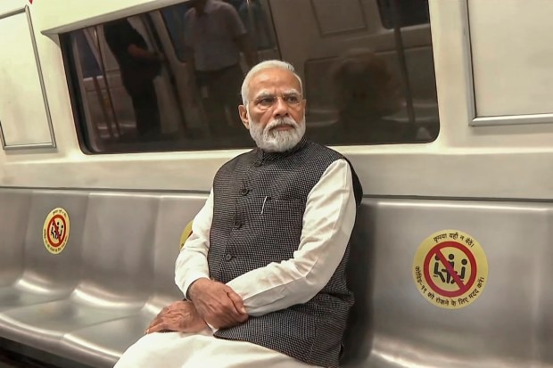Prime Minister Narendra Modi travels in Delhi Metro to reach Delhi University to attend its centenary celebrations, in New Delhi, Friday, June 30, 2023. (PTI Photo)