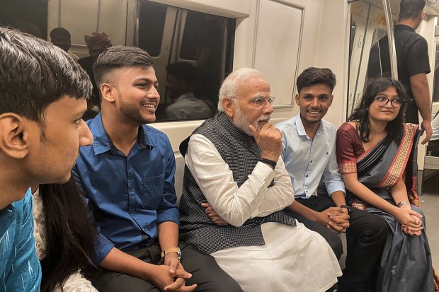 Prime Minister Narendra Modi interacts with passengers as he travels in Delhi Metro to reach Delhi University to attend its centenary celebrations, in New Delhi, Friday, June 30, 2023. (PTI Photo)