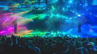 Stage lit up, people in concert