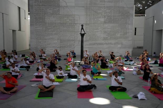 People perform yoga to mark the 9th International Day of Yoga at the Louvre Museum in Abu Dhabi, United Arab Emirates. AP/PTI