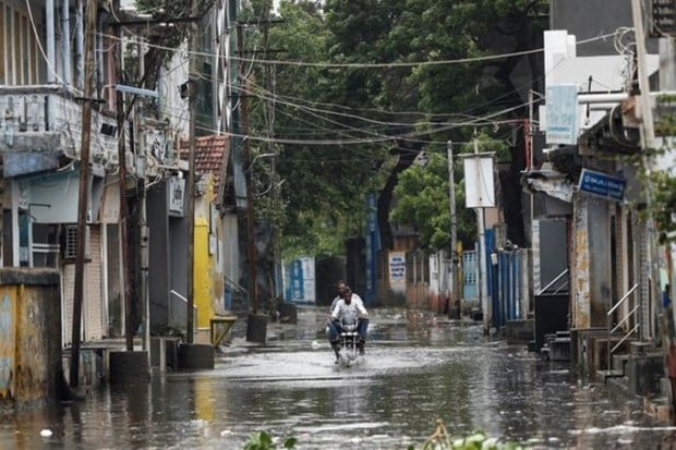 A man rides a motorcycle through a waterlogged street in Mandvi before the arrival of cyclone Biparjoy in the western state of Gujarat, India, June 15, 2023. (Reuters Photo)