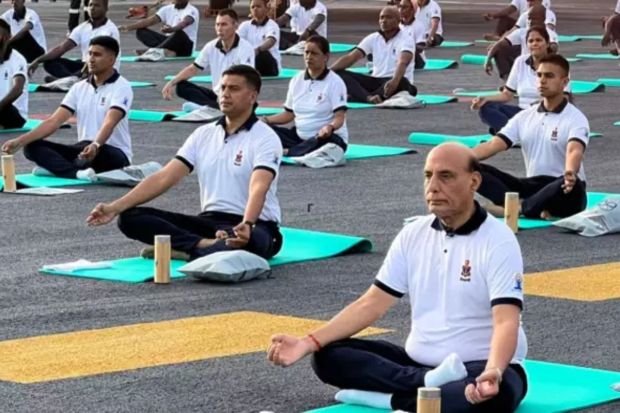 Union Defence Minister Rajnath Singh joined Indian Navy personnel to perform yoga onboard the indigenously built aircraft carrier INS Vikrant on the occasion of International Day of Yoga. (Photo Credits: Twitter)