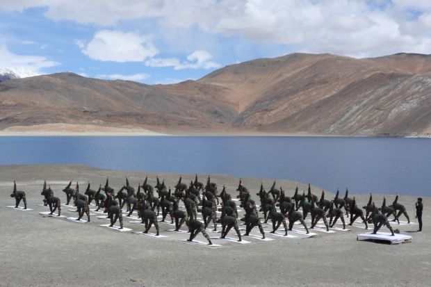 Indian Army personnel performs Yoga at Pangong Tso Lake, situated at a height of almost 13,862 ft. (Photo Credits: ANI)