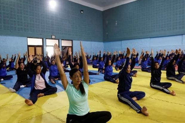 Nepal police personnel perform yoga during International Yoga Day celebrations at the National Police Academy in Kathmandu, Nepal.(Photo Credits: Reuters)