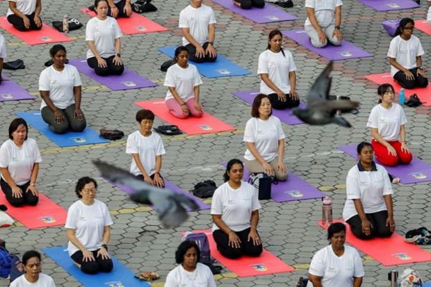 People perform Yoga on the International Day of Yoga in Malaysia’s Batu Caves.(Photo Credits: Reuters)