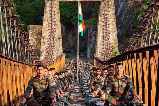 Army jawans practice yoga on a bridge in Jammu region. In the run up to International Yoga Day, Indian Army organised yoga sessions at multiple locations in Jammu region districts-- Poonch, Rajouri, Doda, Kishtwar, Ramban, Reasi & Jammu. (Photo Credits: PTI)