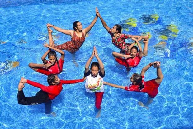Students perform yoga at a swimming pool on the eve of International Yoga Day in Jabalpur on June 20. (Photo Credits: PTI)