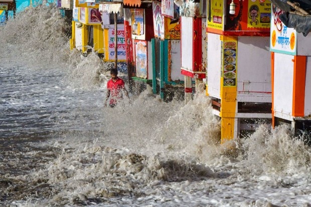 Waves hit the city's waterfront during high tide due to the formation of Cyclone Biporjoy in the Arabian Sea, at Marine Drive in Mumbai. (PTI Photo)