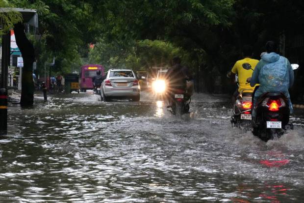 Chennai: Motorcyclists drive past the waterlogged Rajiv Gandhi IT Expressway after rainfall, in Chennai. (PTI Photo)