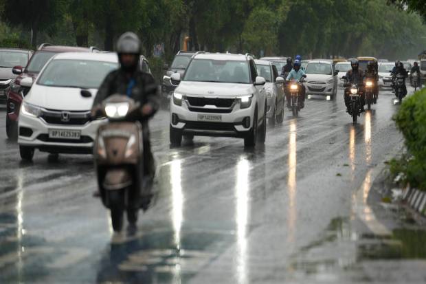 New Delhi: Commuters keeping their vehicles' headlights on during a rainy morning, in New Delhi. (PTI)