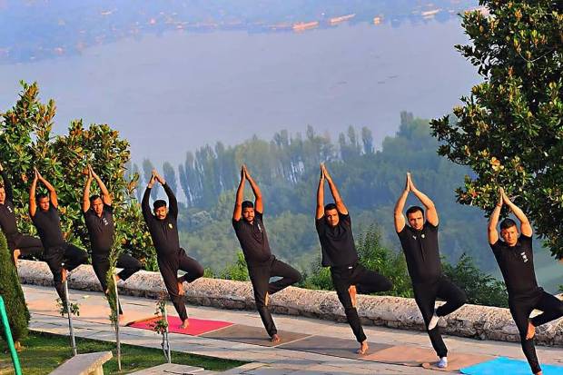 Srinagar: NSG commandos of 13 Special Ranger Group perform yoga on the International Day of Yoga, at Parimahal in the backdrop of Dal Lake, in Srinaga. (PTI Photo)