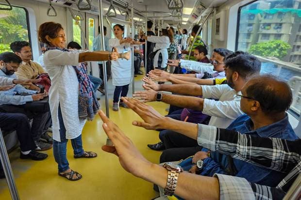 Mumbai: Passengers perform yoga in a Mumbai Metro Line 1 from Versova to Ghatkopar, on International Day of Yoga, in Mumbai. (PTI Photo)