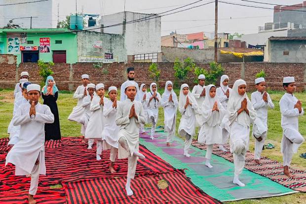 Ghaziabad: Students perform yoga on the International Day of Yoga, at a madrasa in Ghaziabad. (PTI Photo)