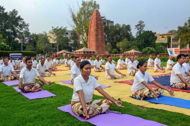 Amritsar: Indo-Tibetan Border Police (ITBP) personnel perform yoga at Jallianwala Bagh, on International Day of Yoga, in Amritsar. (PTI Photo)