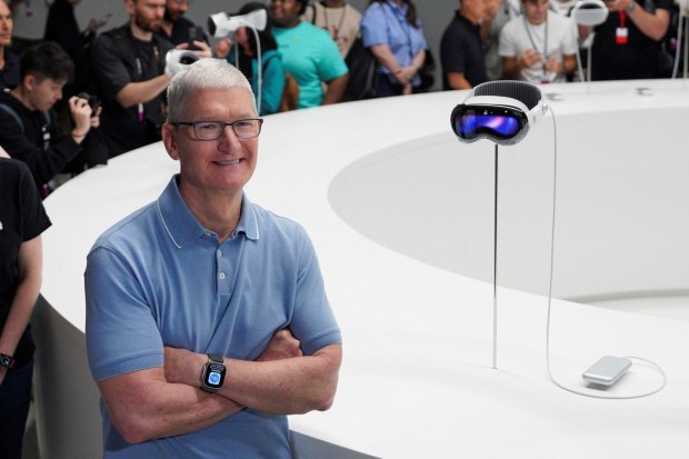 Apple CEO Tim Cook stands next to Apple's Vision Pro headset at Apple's annual Worldwide Developers Conference at the company's headquarters in Cupertino, California, U.S. on June 5, 2023. (Image: REUTERS)