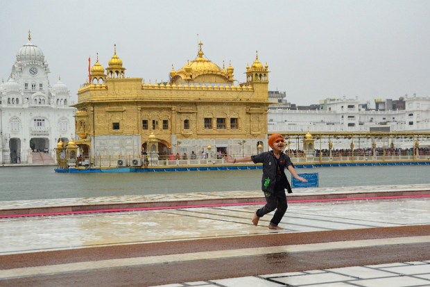 A child enjoys rain at the Golden Temple in Amritsar on May 31, 2023. (Image: PTI)