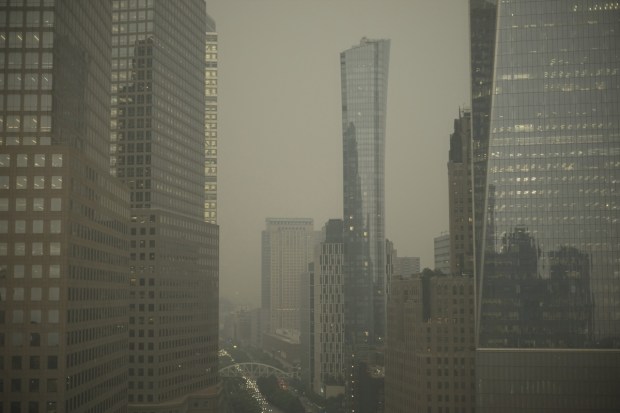 Buildings in lower Manhattan in New York are partially obscured by smoke from Canadian wildfires. (Image: AP Photo/Patrick Sison)