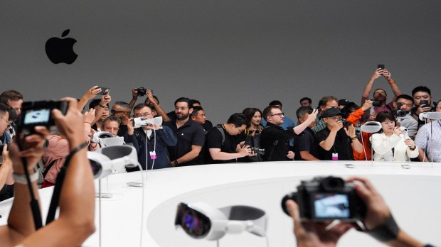 People use phones as Apple's Vision Pro headsets are on display at Apple's annual Worldwide Developers Conference at the company's headquarters in California, U.S. (Image: REUTERS)