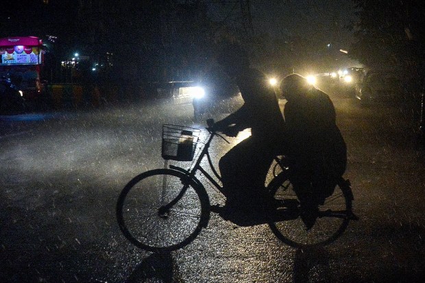 Vehicles move on a road amid rain in Ghaziabad. (Image: PTI)