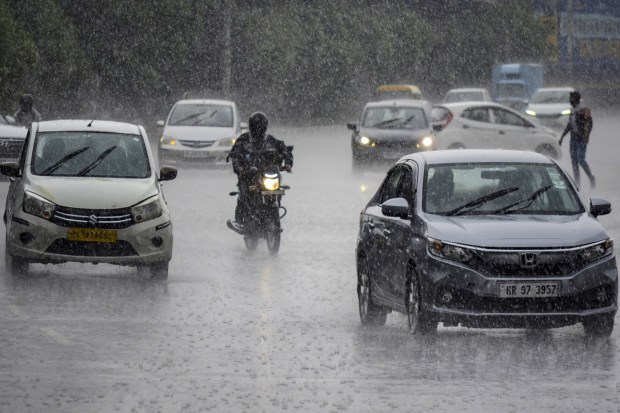 Vehicles in Gurugram amid heavy rainfall. Many parts of Haryana received a fresh spell of rain, keeping the minimum temperature below the season's normal. (Image: PTI)
