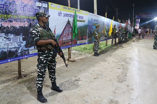 Security forces personnel keep vigil as a convoy of the first batch of pilgrims leaves for Kashmir. (Image: PTI)
