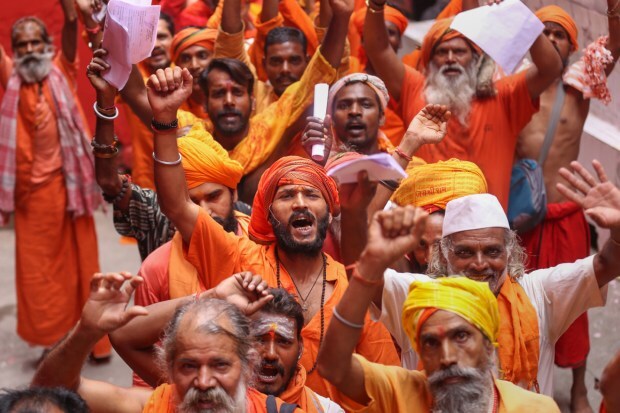 Sadhus wait to get themselves registered at Ram Mandir base camp in Jammu on June 30