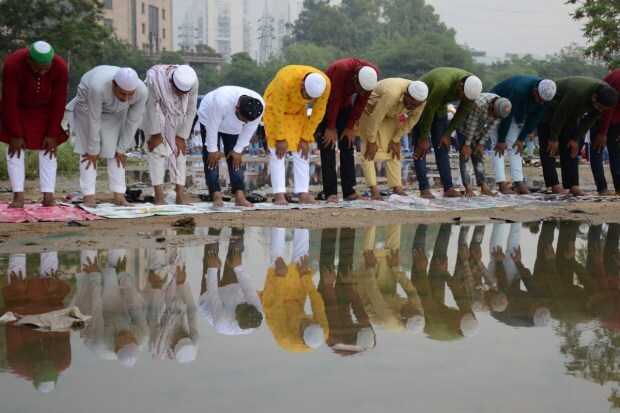 Men offer prayers on the occasion of Eid al-Adha festival, at Leisure Valley ground, in Gurugram. (Image: PTI)