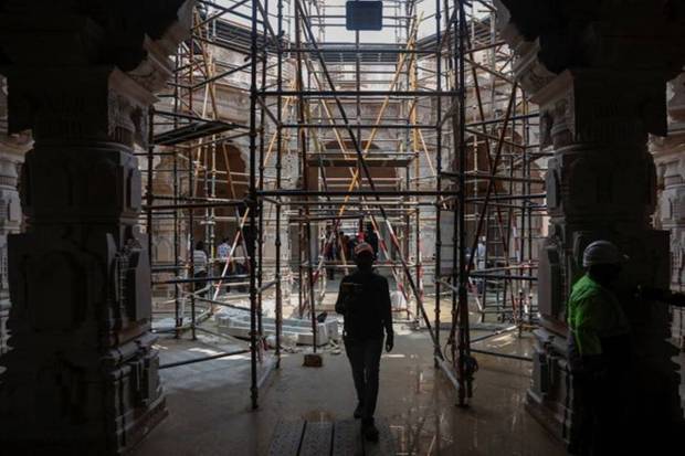 In UP's Ayodhya, a man walks inside the under construction Hindu Ram Temple. REUTERS
