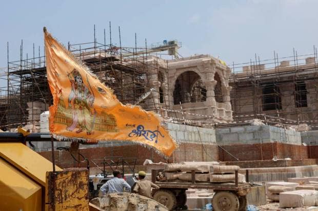 A religious flag is seen in front of the under-construction Hindu Ram Temple in Ayodhya. REUTERS