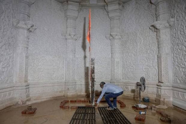 A man touches the place where the idol of Lord Ram will be placed inside the under-construction Hindu Ram Temple in Ayodhya. REUTERS