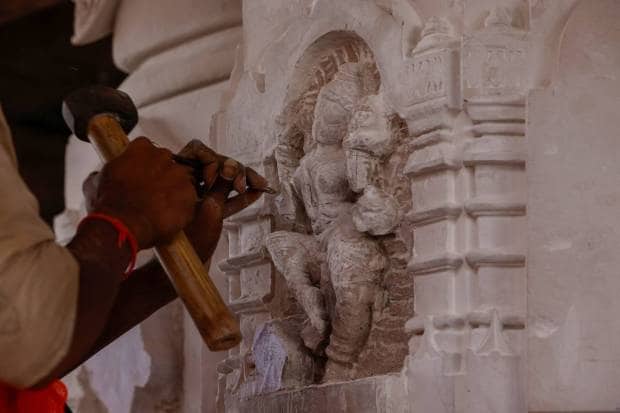 A worker carves a stone pillar inside the under-construction Hindu Ram Temple in Ayodhya. REUTERS