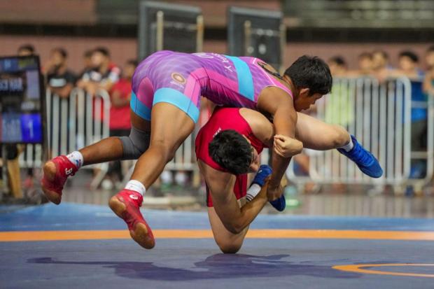 Sonika (in red) of Himachal Pradesh and Pushpa Yadav of Uttar Pradesh compete in the women's 62kg category event during the Asian Games 2023 wrestling trials.