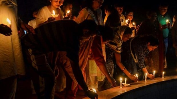 People take part in a candle march to protest against the sexual violence against women in Manipur in Gurugram on July 22. (Image: PTI)
