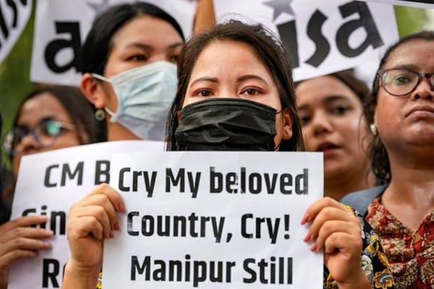 Protestors hold placards as they attend a protest in New Delhi on July 21. (Image: Reuters)