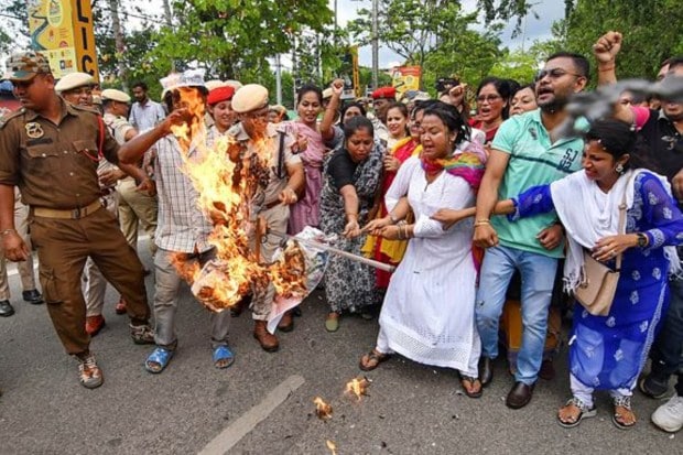 Members of Opposition parties burn an effigy during a protest against the alleged controversial remarks of Assam CM Himanta Biswa Sarma over Manipur sexual assault case in Guwahati on July 22. (Image: PTI)