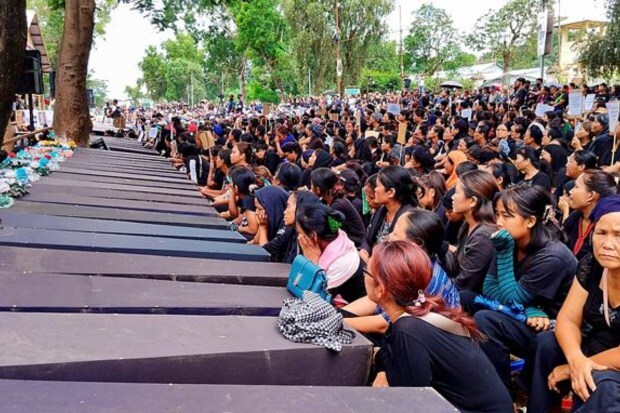 Women's wing of the Indigenous Tribal Leaders' Forum (ITLF) stage a protest near the 'Wall of Remembrance' erected to honour lives lost during the ongoing ethnic violence in Churachandpur on July 22. (Image: PTI)
