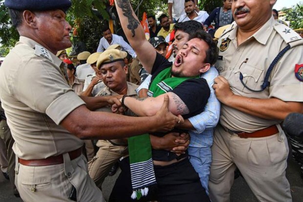 Police detain members of Assam Pradesh Youth Congress during a protest outside Rajiv Bhavan in Guwahati on July 21. (Image: PTI)