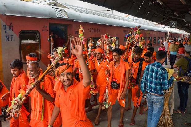 Kanwariyas arrive at Patna railway station before leaving for their pilgrimage during the holy month of Shravan month, in Patna. (PTI Photo)
