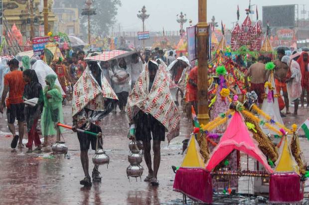 Lord Shiva devotees or Kanwariyas at Har Ki Pauri Ghat to collect holy water from the Ganga river for 'Kanwar Yatra' pilgrimage during the holy month of 'Shravan', in Haridwar. (PTI Photo)